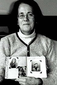 Ms. Pawel holding photos of family